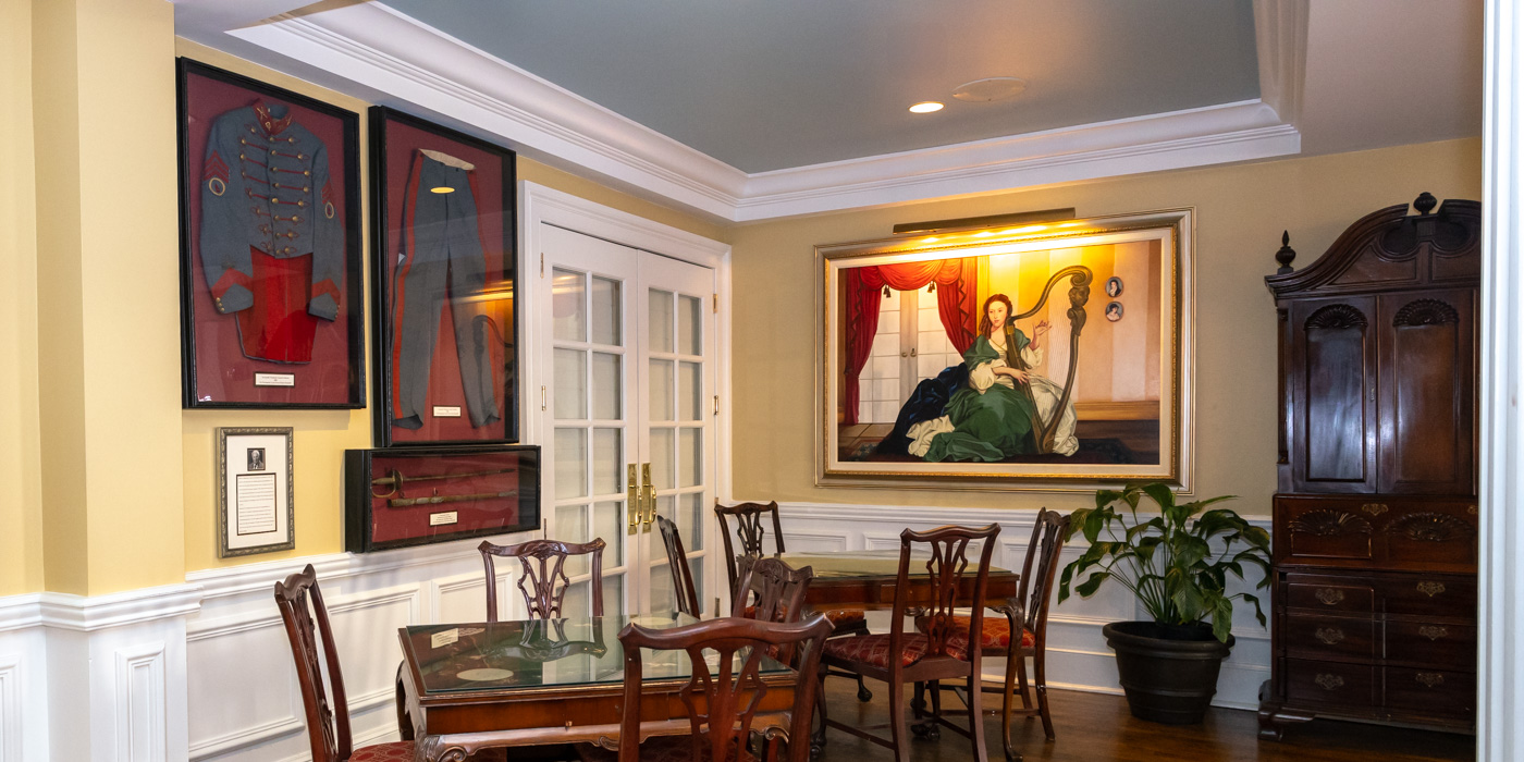 a dining room with a painting on the wall