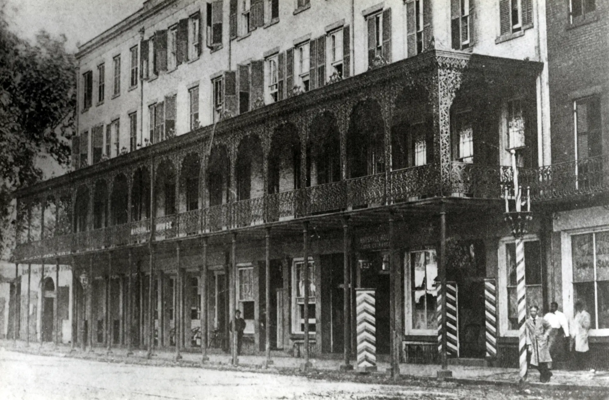 An old photograph of the Marshall House from the 1870s, prominently featuring its iconic cast-iron veranda