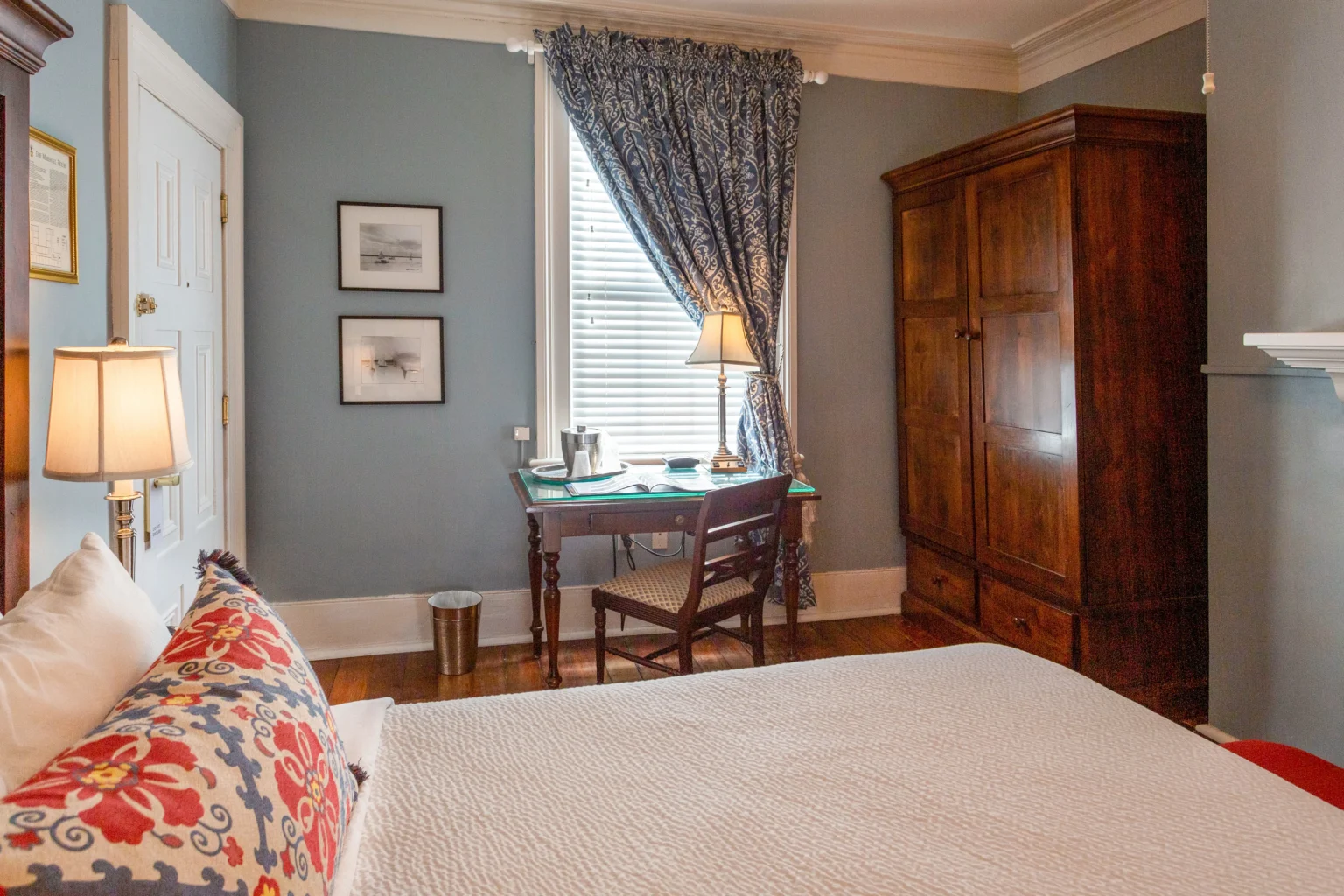 desk, bed, and armoire in the classic queen room at the Marshall House hotel