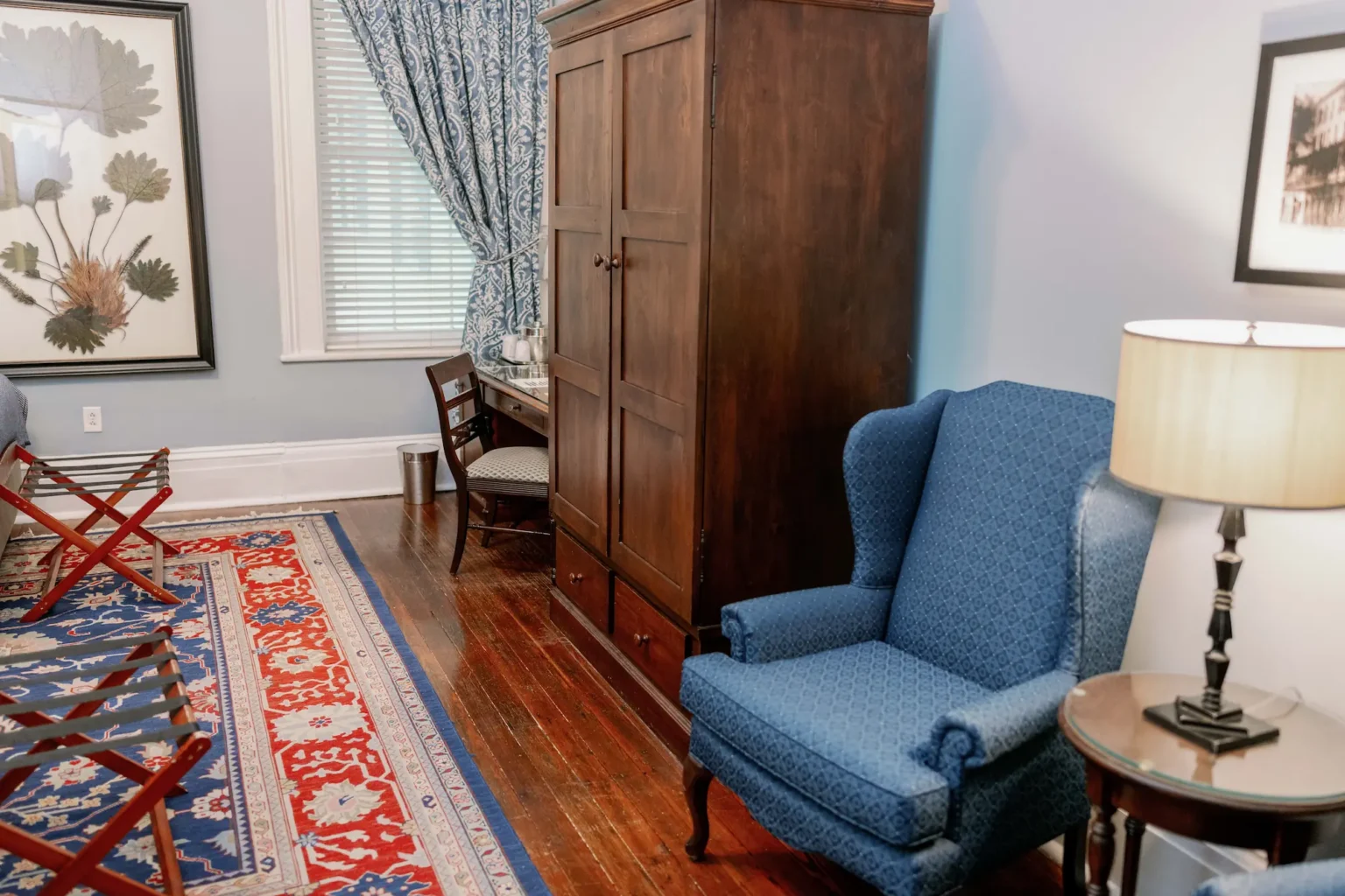 easy chair, armoire, and desk in the double queen room at the Marshall House hotel