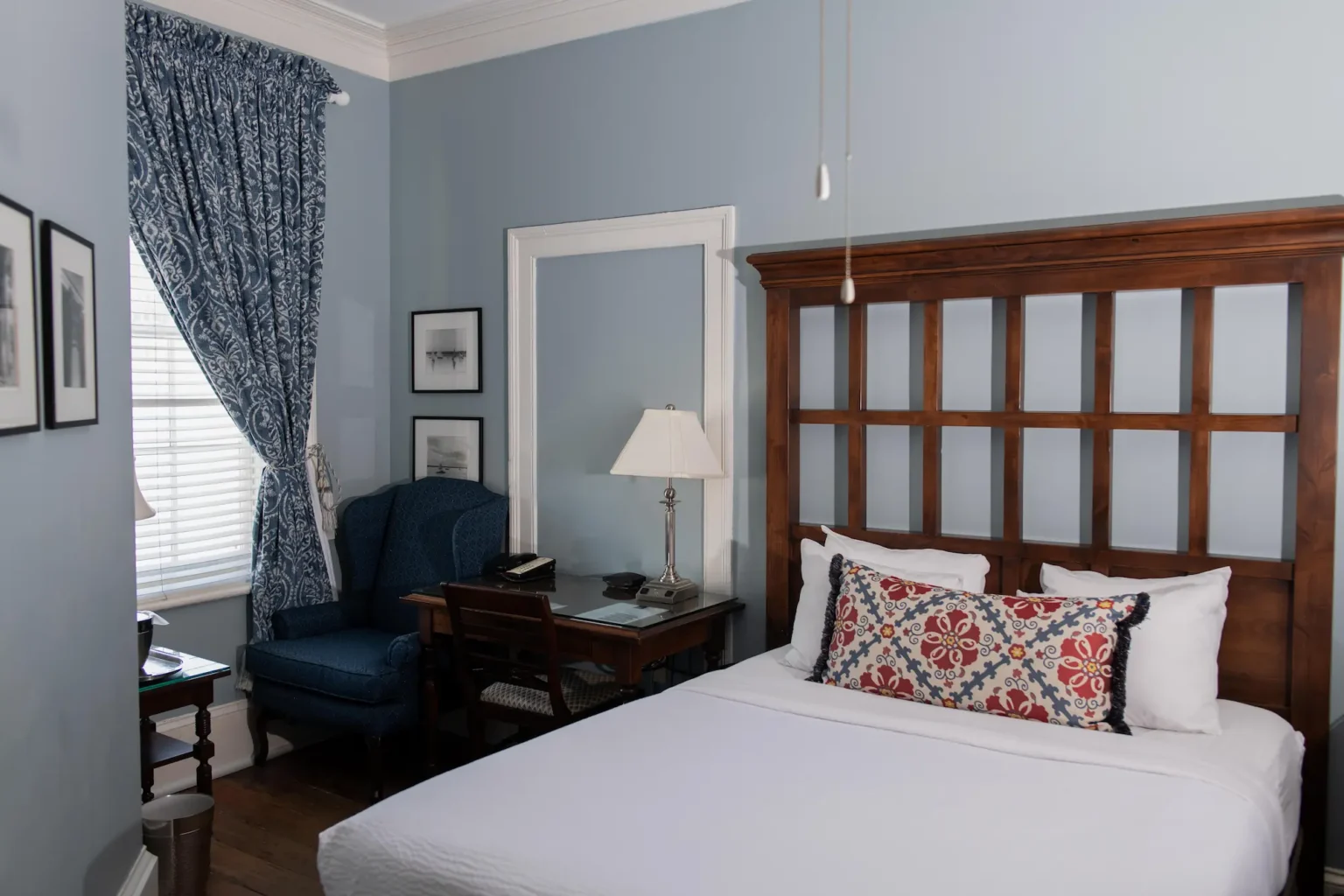 Full Bed at the Marshall House with an easy chair and a sidetable