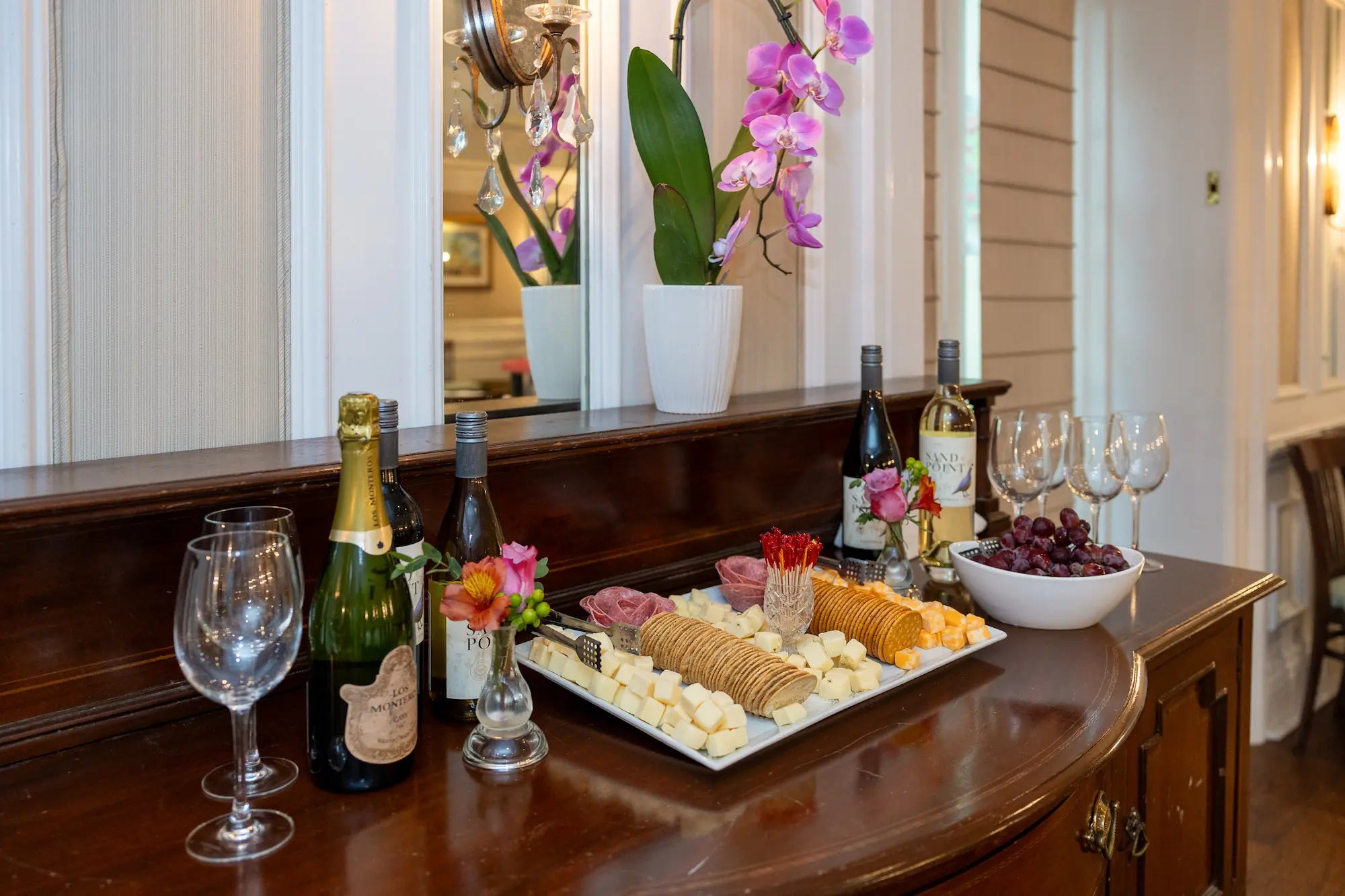 The spread of cheeses, crackers, grapes, and other bites, with red and white wine, at the evening social at the Marshall House