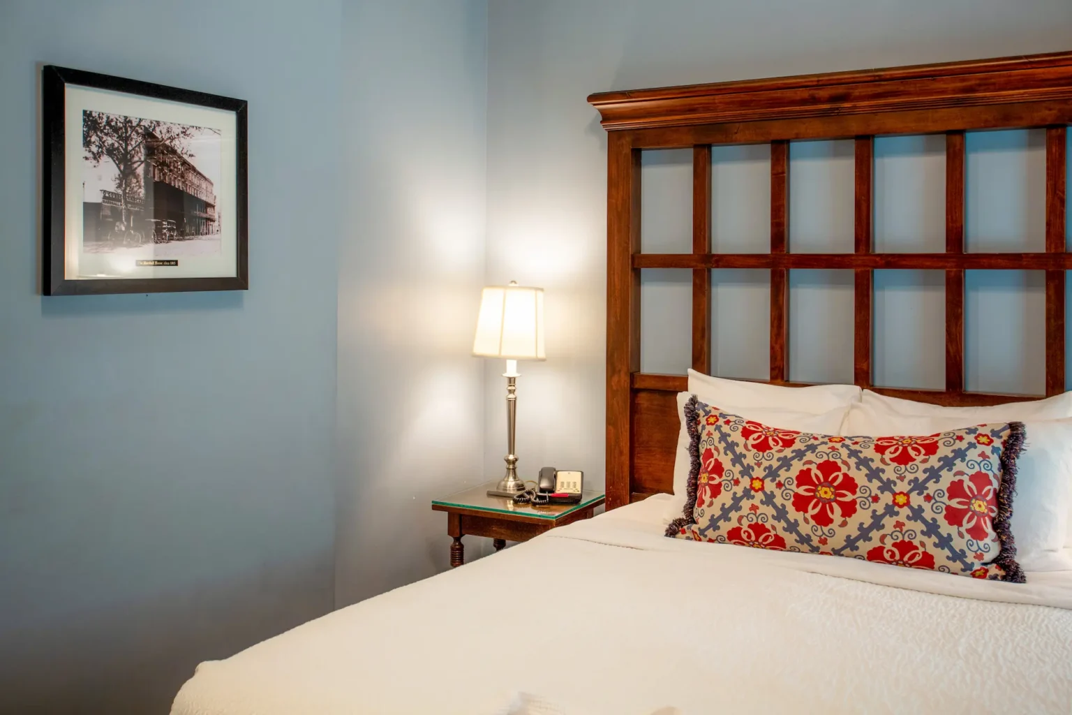 detail of the bed and side table of a petite queen room at the Marshall House hotel