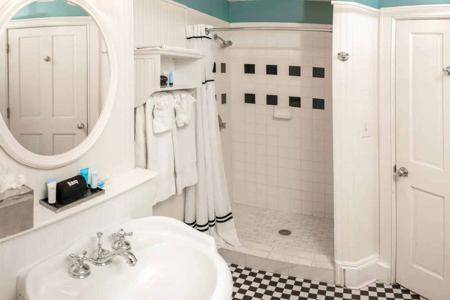 a shower and vanity in the Mary Marshall Suite at the Marshall House hotel