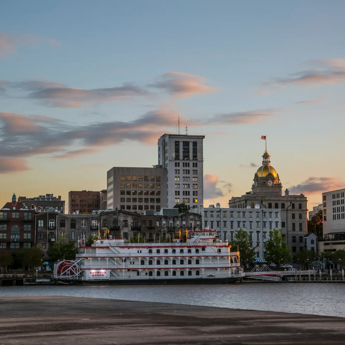 the skyline of Savannah at dusk, as seen from the riverfront