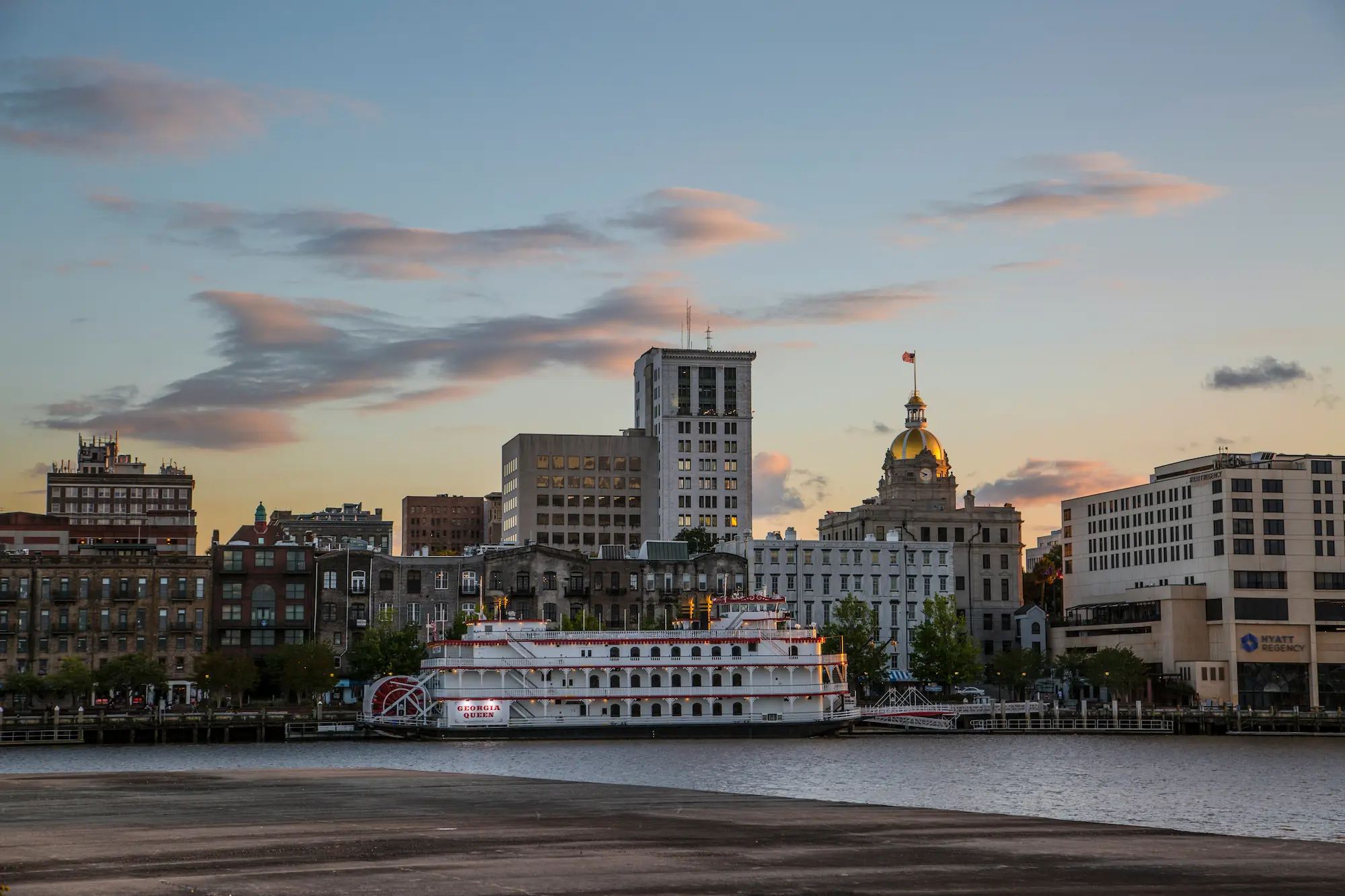 the skyline of Savannah at dusk, as seen from the riverfront